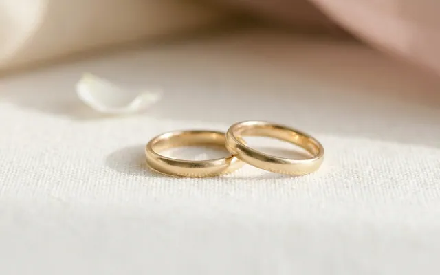 a pair of gold wedding rings on an elegant background